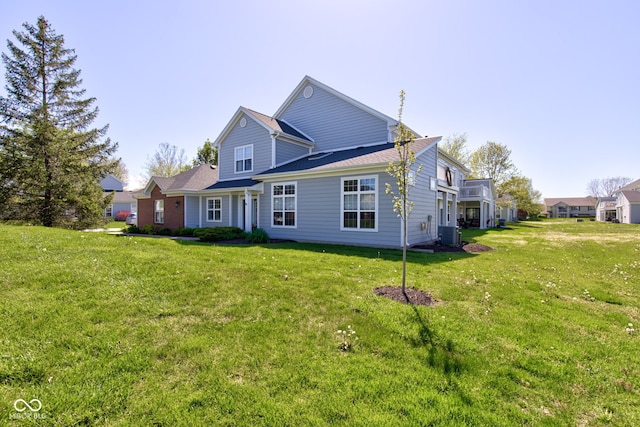 back of house with a yard and cooling unit