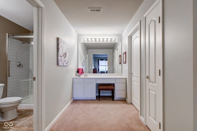 full bathroom with visible vents, vanity, toilet, baseboards, and a shower stall