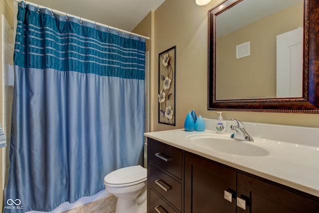 bathroom featuring vanity, toilet, and a shower with curtain