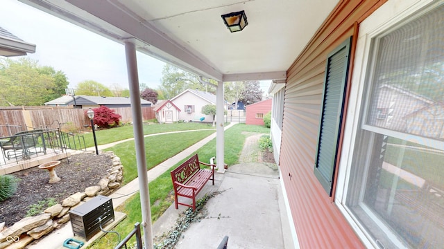 view of patio featuring fence and a residential view