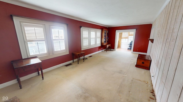 interior space with crown molding, baseboards, and visible vents
