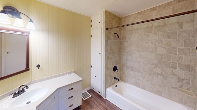 bathroom with shower / bath combination, wood finished floors, visible vents, and vanity