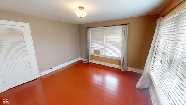 unfurnished bedroom with baseboards and wood finished floors