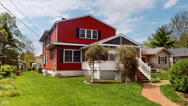 rear view of property with a lawn