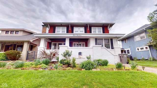 view of front of home featuring covered porch and a front yard