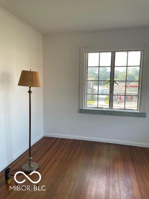 302 E Main St, Greenfield, IN 46140 - spare room with baseboards and dark wood-style flooring