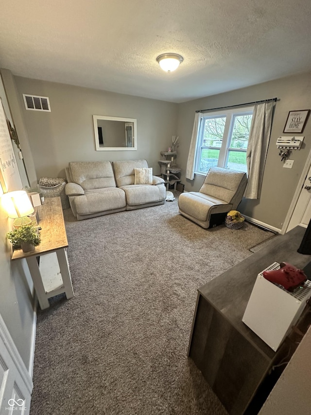 carpeted living room featuring a textured ceiling and visible vents