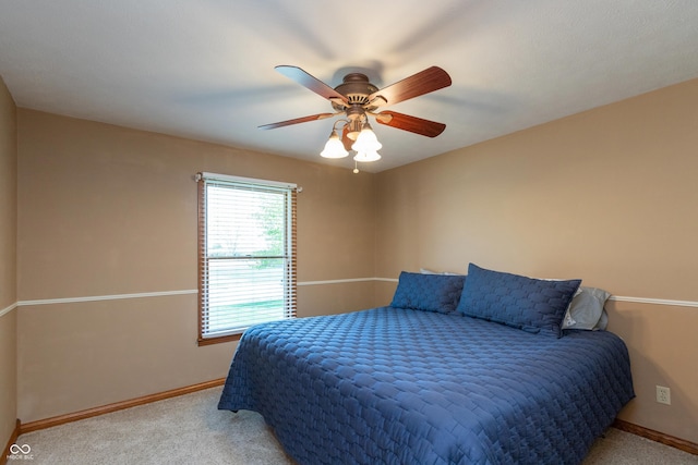 bedroom with carpet floors, baseboards, and a ceiling fan