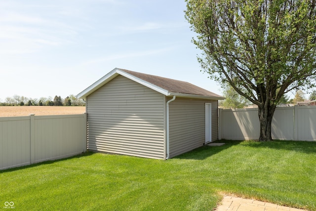 view of outdoor structure featuring fence private yard and an outdoor structure