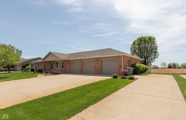 single story home with an attached garage, concrete driveway, a front yard, and brick siding