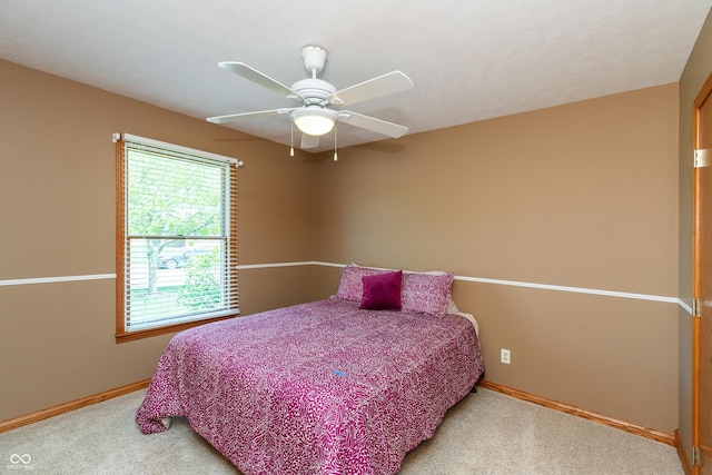 bedroom featuring baseboards, a ceiling fan, and carpet