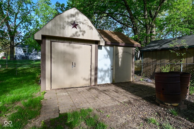 view of shed featuring fence