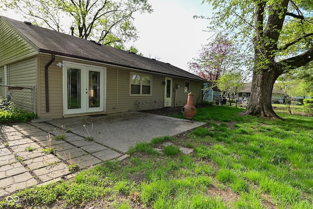 back of property featuring fence, a patio, and a yard