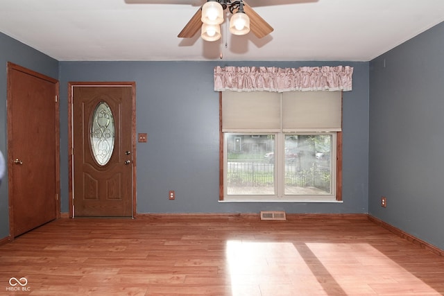 entryway featuring a ceiling fan, visible vents, and light wood finished floors