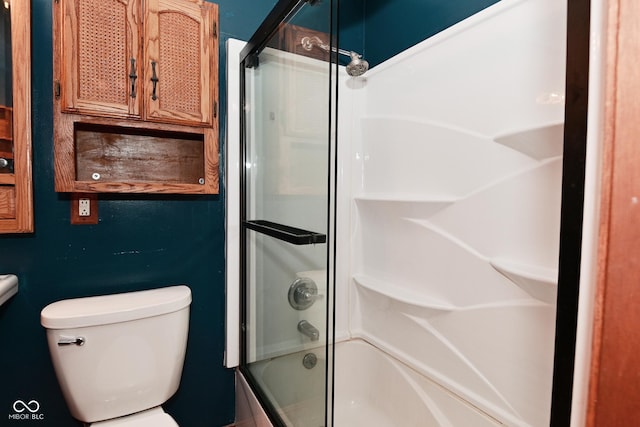 bathroom featuring bath / shower combo with glass door and toilet