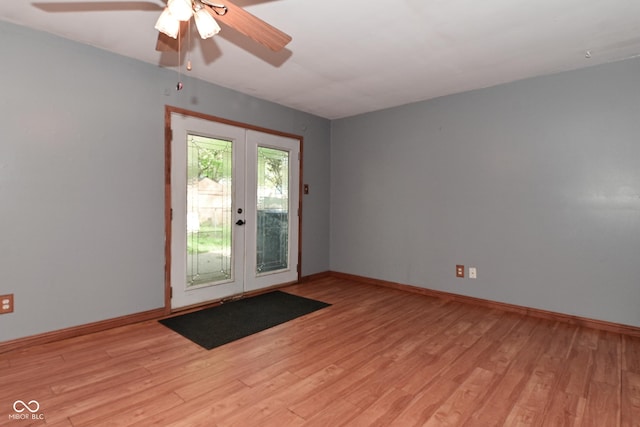 spare room with a ceiling fan, baseboards, french doors, and light wood-type flooring