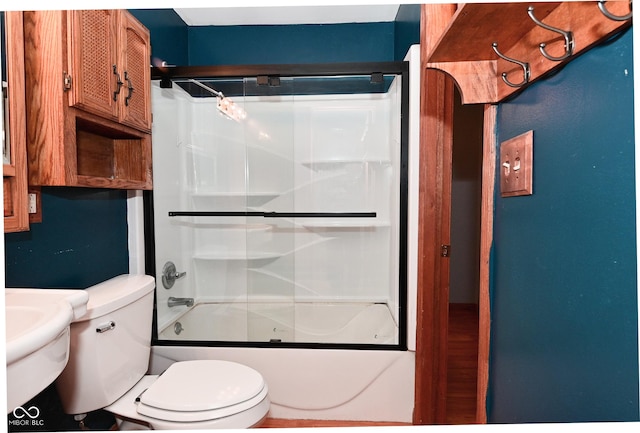 full bathroom with bath / shower combo with glass door and toilet