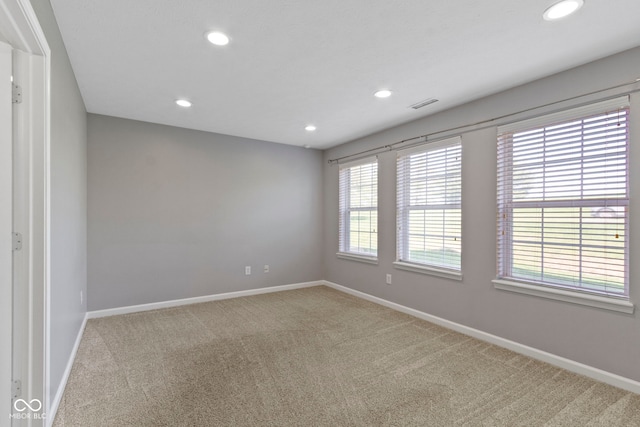 empty room with recessed lighting, baseboards, visible vents, and carpet