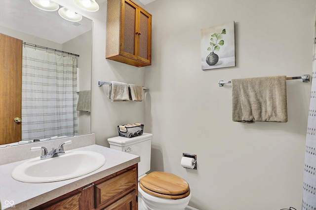 bathroom featuring vanity, toilet, and a shower with curtain