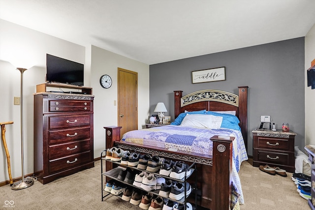 bedroom with baseboards and light colored carpet