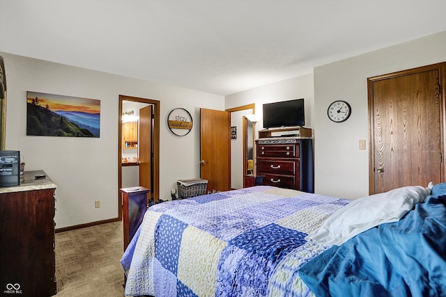 bedroom with baseboards and light carpet