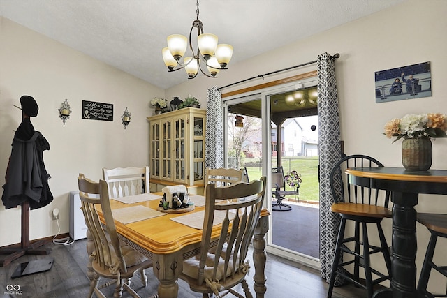 dining space featuring dark wood-type flooring, baseboards, and a chandelier