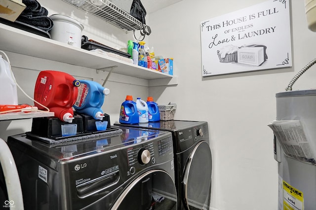 washroom with washing machine and clothes dryer, laundry area, and electric water heater