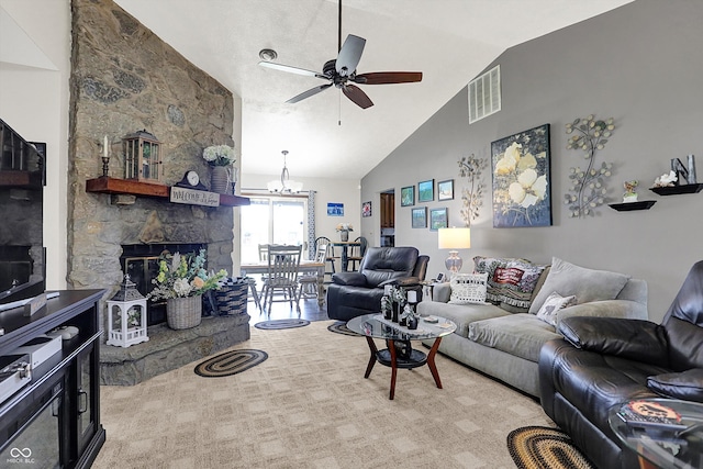 living room featuring high vaulted ceiling, visible vents, ceiling fan with notable chandelier, and a fireplace