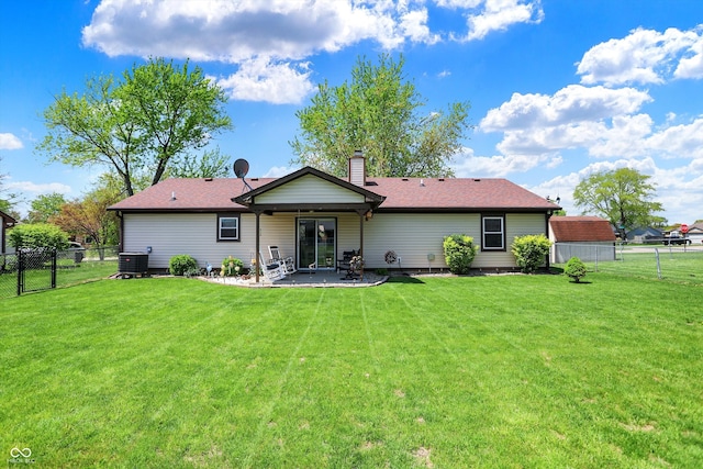 back of property featuring central AC unit, a patio area, a fenced backyard, and a yard
