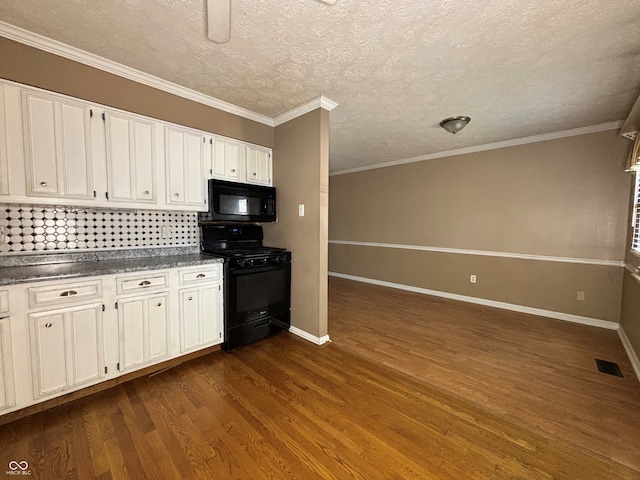 kitchen with dark countertops, baseboards, white cabinets, dark wood finished floors, and black appliances
