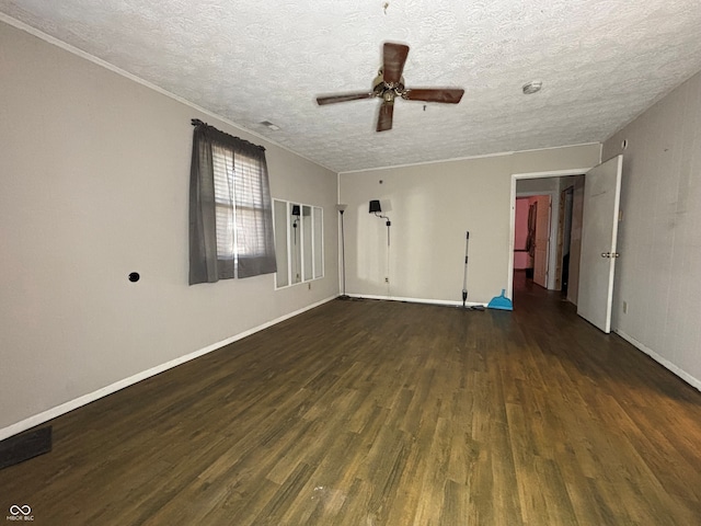 empty room with baseboards, a textured ceiling, ceiling fan, and wood finished floors
