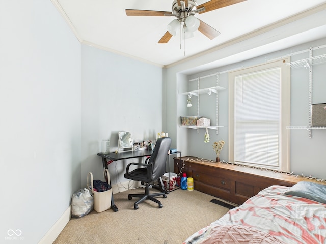 carpeted bedroom featuring ornamental molding and a ceiling fan