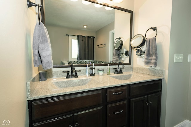full bathroom featuring double vanity and a sink