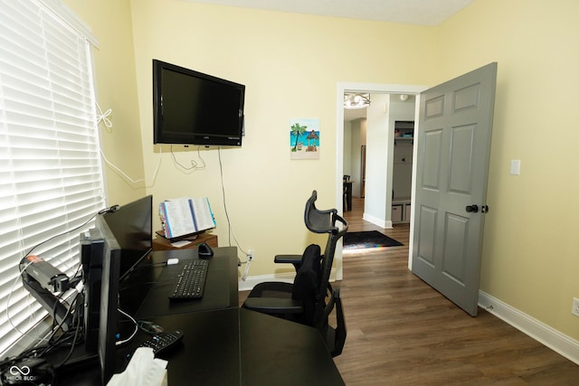 home office with baseboards and wood finished floors