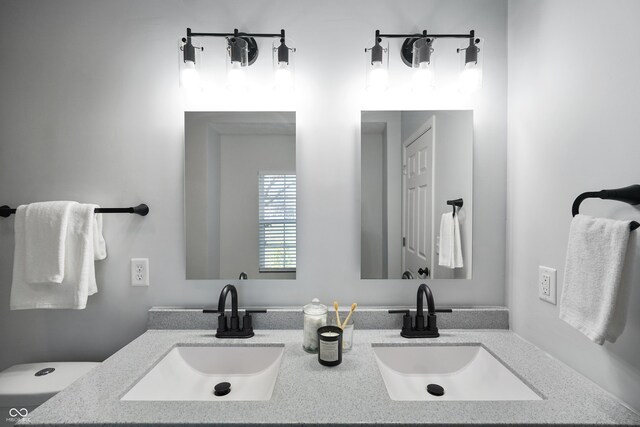 1417 E Michigan St, Indianapolis, IN 46201 - bathroom featuring double vanity, toilet, and a sink