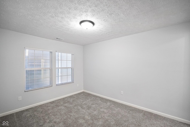 1417 E Michigan St, Indianapolis, IN 46201 - carpeted spare room with a textured ceiling, baseboards, and visible vents