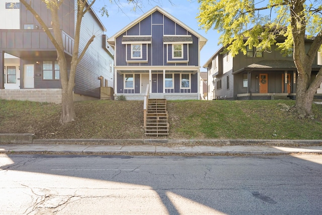 1417 E Michigan St, Indianapolis, IN 46201 - view of front facade featuring a front lawn, covered porch, and stairway