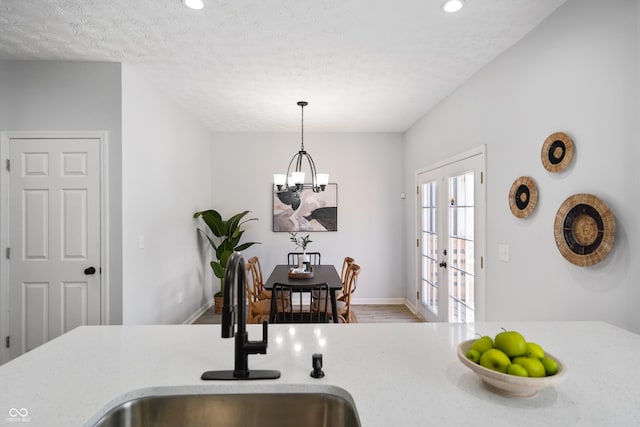 1417 E Michigan St, Indianapolis, IN 46201 - kitchen featuring recessed lighting, a sink, wood finished floors, and a notable chandelier