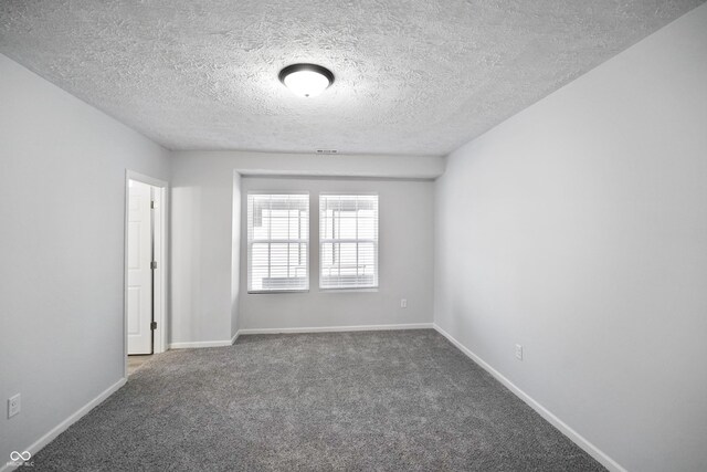 1417 E Michigan St, Indianapolis, IN 46201 - carpeted empty room with baseboards and a textured ceiling