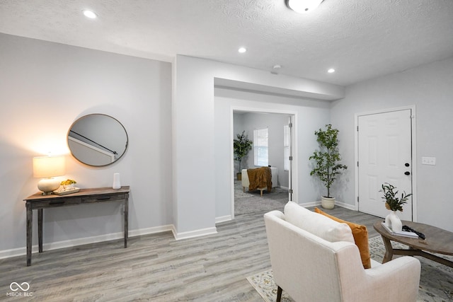 1417 E Michigan St, Indianapolis, IN 46201 - living room with light wood-type flooring, recessed lighting, a textured ceiling, and baseboards