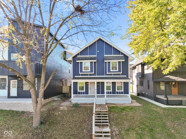 1417 E Michigan St, Indianapolis, IN 46201 - view of front of house featuring covered porch, board and batten siding, central AC unit, and stairway