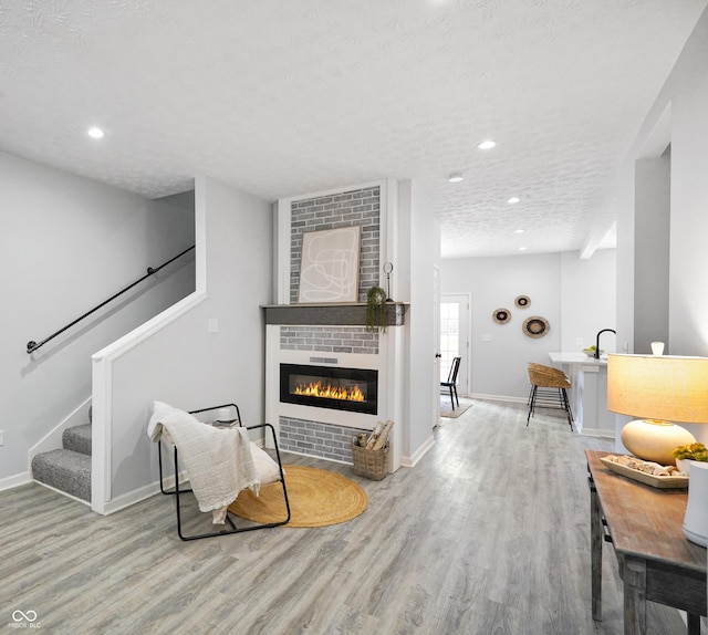 1417 E Michigan St, Indianapolis, IN 46201 - living area with baseboards, wood finished floors, and a fireplace