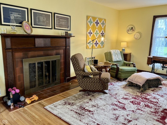 2405 Sycamore St, Columbus, IN 47201 - sitting room featuring a tiled fireplace and wood finished floors