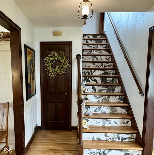 2405 Sycamore St, Columbus, IN 47201 - stairs featuring wood finished floors and baseboards