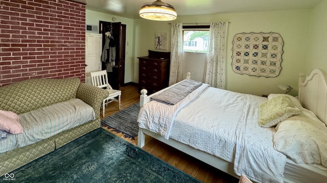 2405 Sycamore St, Columbus, IN 47201 - bedroom with wood finished floors and brick wall