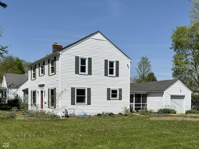 2405 Sycamore St, Columbus, IN 47201 - rear view of property featuring a chimney, an attached garage, and a lawn