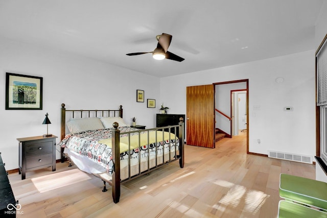 bedroom with visible vents, a ceiling fan, baseboards, and light wood-type flooring