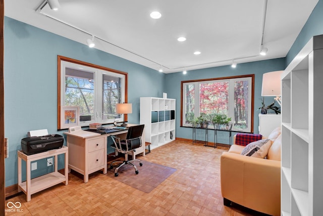 office with baseboards, track lighting, and a wealth of natural light