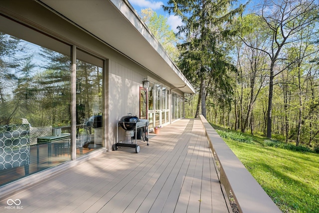 wooden terrace with a lawn