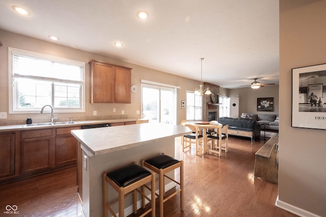 kitchen with plenty of natural light, a sink, dark wood-style floors, and light countertops